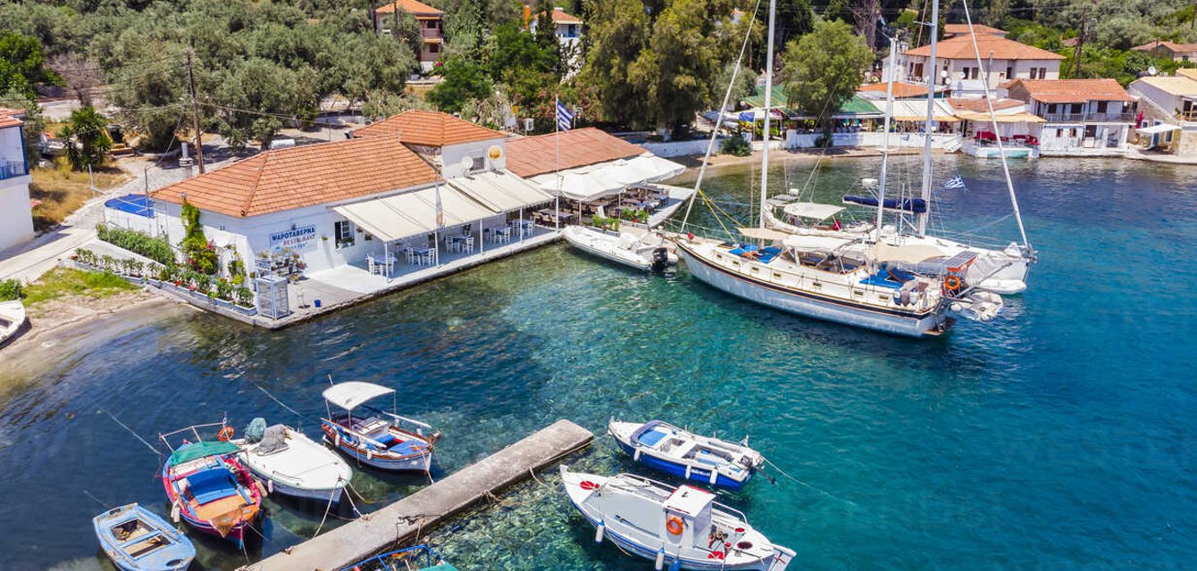 Sailing yachts and luxury boats anchored in the picturesque Trikeri Island in the Pagasetic Gulf, Greece